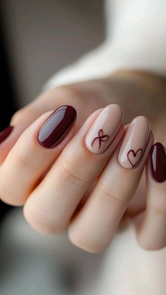 Burgundy and nude nails with heart and bow